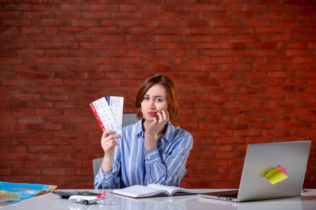 Spanish Non Lucrative Visa for Living in Spain 8 front view travel agent sitting her working place with plane tickets agency service global manager assistant world map operator