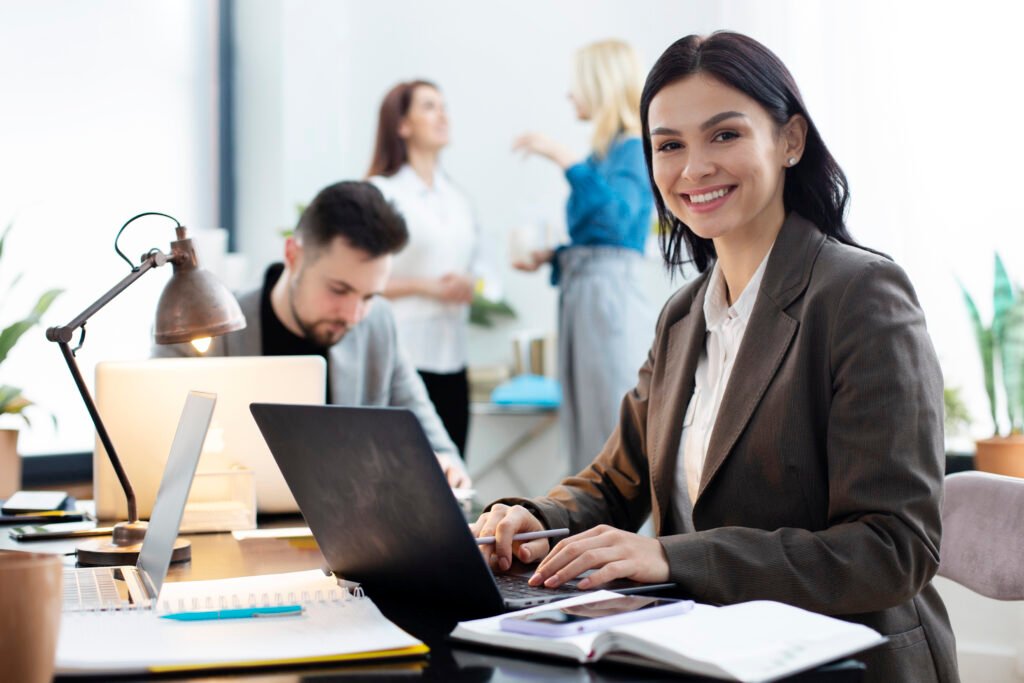 medium shot woman working laptop