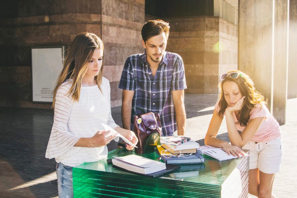 youngsters posing outside with books